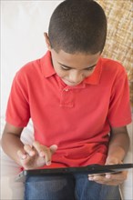 Hispanic boy using digital tablet