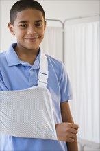 Hispanic boy with arm in sling