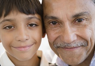 Smiling Hispanic grandfather and grandson