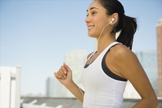 Caucasian woman jogging with earphones