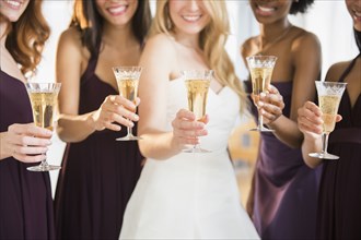 Bridesmaids and bride toasting with champagne