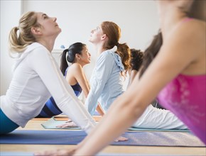 Women practicing yoga in class