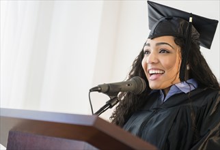 Hispanic student giving speech at graduation