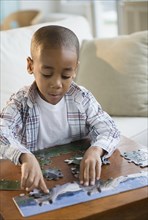 African American boy playing with jigsaw puzzle