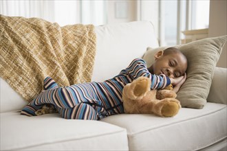 African American boy napping on sofa