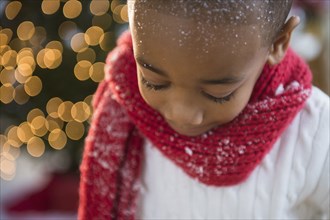 African American boy wearing scarf in snow
