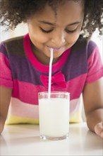 African American girl drinking glass of milk