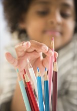 African American girl picking out colored pencil