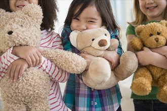 Girls hugging teddy bears