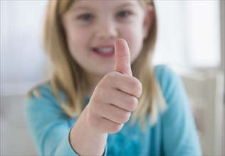 Caucasian girl giving thumbs-up