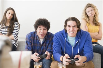 Men with video games ignoring girlfriends