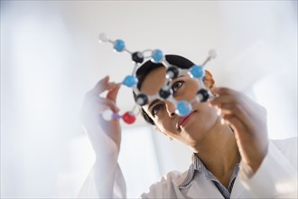 Indian scientist examining molecular model in lab