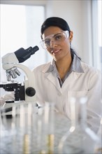 Indian scientist using microscope in lab