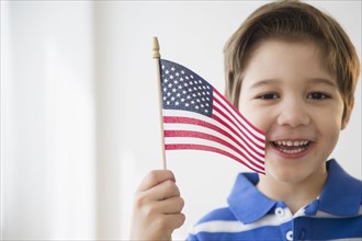 Hispanic boy waving American flag