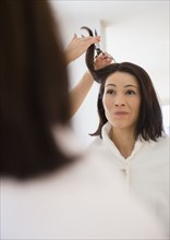 Caucasian woman having hair cut in salon
