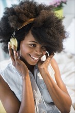 Mixed race woman listening to headphones