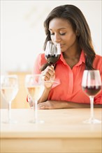 Black woman smelling wine