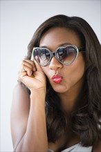 Black woman wearing heart-shape sunglasses