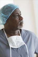 Black surgeon standing in hospital