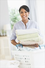 Black woman folding laundry
