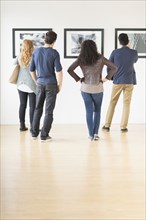 People admiring art in gallery