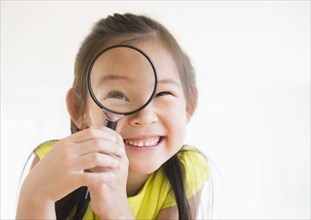 Korean girl using magnifying glass