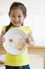 Korean girl showing cleared plate