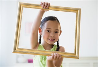 Korean girl holding empty picture frame
