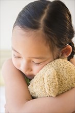 Korean girl hugging teddy bear