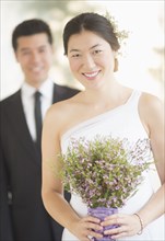 Newlywed bride holding bouquet at wedding