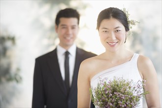 Newlywed bride holding bouquet at wedding