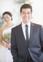 Newlywed groom smiling at wedding