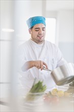 Mixed race chef cooking in restaurant