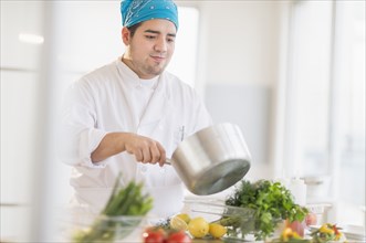 Mixed race chef cooking in restaurant