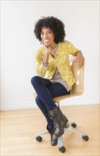 African American woman sitting in office chair
