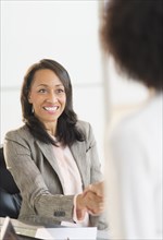 African American businesswomen shaking hands