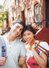 Couple smiling outside brownstones