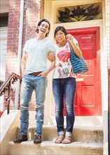 Couple standing on front stoop with house key
