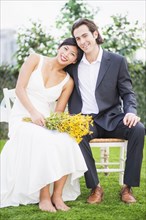 Newlywed couple smiling outdoors