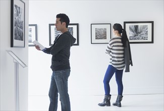 People admiring photograph art in gallery