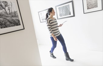 Korean woman admiring art in gallery