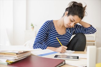 Asian student studying at table