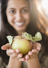 Close up portrait of Asian woman holding fresh apple