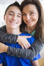 Close up portrait of Caucasian mother and son hugging