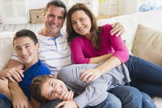 Portrait of smiling Caucasian family on sofa