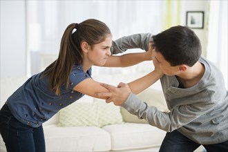 Caucasian brother and sister fighting