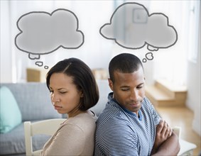Thought bubbles above frustrated couple