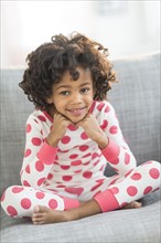 Portrait of smiling African American girl in pajamas