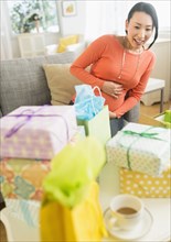Pregnant Japanese woman looking at baby shower gifts