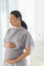 Pregnant Japanese woman in hospital gown